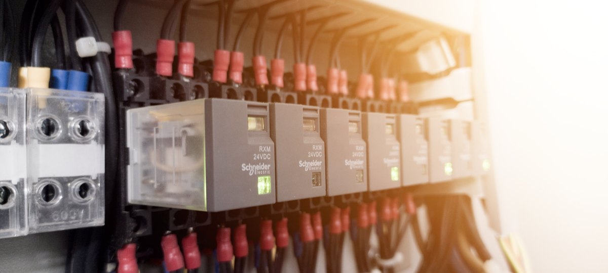 Close-up of relays and terminal blocks on a monitoring panel
